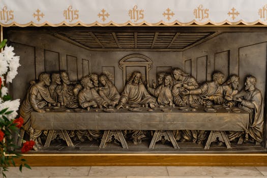 Close-up view of a detailed Last Supper metal relief sculpture, symbolizing a famed biblical scene.